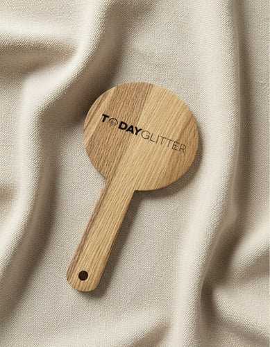 Today Glitter wooden handheld mirror resting on soft beige fabric – sustainable beauty accessory with clean minimalist design.